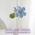 Handmade crochet Aleurites flower in light blue yarn with yellow center and green leaf - Blue Paulownia Flower Single Stem