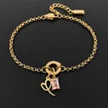 Gold plated stainless steel bracelet featuring a pink rectangular gem and heart pendant - Letter I
