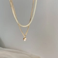 Collana a doppio strato in maglia serpente dorata con pendente tondo in zircone - Oro