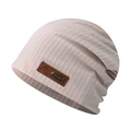 Detail of pink ribbed beanie showing leather patch with metal fishbone accent and logo - One Size / Beige