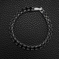 Macro shot of silver tennis bracelet featuring black round cubic zirconia and safety clasp - 5mm-17cm / Black Zirconia