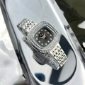 Detailed close-up of a silver square watch with rhinestones on a reflective surface - Silver Band Black Dial