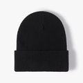 Classic black ribbed knit beanie hat for winter outdoor warmth in a minimalist style - Black