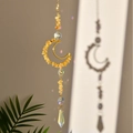 Macro shot of suncatcher moon frame with yellow crystals and rainbow prism pendant - Citrine