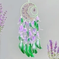 Dream catcher featuring purple amethyst stones and tree of life with green feathers - Purple
