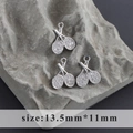 Detail of three rhodium-plated tennis racket charms with white cubic zirconia inlays - Tennis Racket Style (M100305)