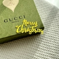 Macro shot of green paisley embossed gift box with yellow Merry Christmas lettering - Gold / Regular Style A / Plus Thick Style