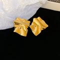 Detail view of gold irregular crinkled square earrings with high polish mirror texture - Gold
