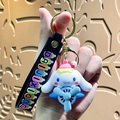 Cinnamoroll silicone keychain featuring a blue propeller plane and black wrist strap - Sanrio Airplane-Cinnamoroll