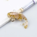 Miniature koi fish ornament made of resin with gold foil flakes and pink crystal stones - Rose Quartz