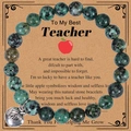 Close-up of a teacher appreciation stone bracelet with a silver apple charm on a card - African Pine Stone