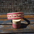 Detail of handwoven raffia headband with red textured patterns on a vintage jar - Rose Red and Beige Patchwork Wide Edge