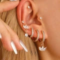 Gold ear piercing set with clear zircon stones on ear, featuring studs and hoops - Three Leaf Petal Combination Style (DZ-255)