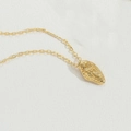 Vintage gold plated necklace with irregular oval textured pendant and engraved symbol - Rock Texture Style