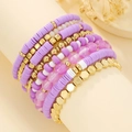 Macro shot of purple and white Heishi bead bracelets with gold accents on display - Purple White Gold Layered Style (SY0621-1)