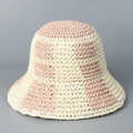 Detailed view of checkered pink and beige hand-woven straw bucket hat for sun protection - M (56-58cm) / Pink