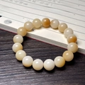 Burnt cat paw Bodhi root bracelet with natural cream and light brown beads on wood - Creamy Yellow Round Beads