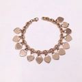 Rose gold thick chain bracelet with multiple heart charms on a pink background - Rose Gold