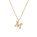 Gold plated letter M pendant necklace with shimmering white crystals on a cross chain - Letter M / Gold