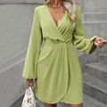 Detail view of the deep V-neckline and draped waist of this lime green long sleeve mini dress - S / Yellow-Green