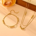 Elegant gold-plated titanium steel jewelry set featuring double-layer snake chains with beads - Gold Double Layer Necklace Bracelet Set