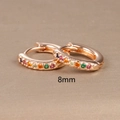 Detail view of 8mm rose gold huggie hoop earring with rainbow cubic zirconia stones - 8mm / Rose Gold