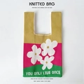 Detail of knitted bucket bag featuring floral pattern and YOU ONLY LIVE ONCE text - Yellow Red Three Flowers