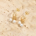 Detailed close-up of vintage hollow heart earrings with white pearls on a stone background - C-Shape Double Pearl