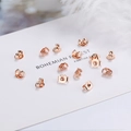 925 silver rose gold earring backs in butterfly and disc styles on white paper - Rose Gold