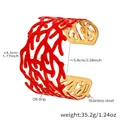 Detail showing red coral hollow pattern on wide stainless steel 18k gold plated cuff - Coral Branch Hollow Style (Z439) / Gold & Coral Red