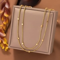Double layered gold snake bone necklace with geometric beads on brown leather - Double Layer Cube Necklace / Gold