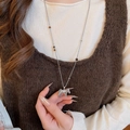 Silver horse pendant necklace with tassel and dark beads worn on a brown sweater - 13# Necklace Silver Pony Tassel