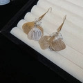 Detail view of two-tone gold and silver hollow leaf earrings with small white pearls - Hook Style / Silver