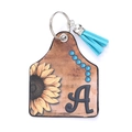Porte-clés en cuir style western avec tournesol, lettre A et pompon bleu ciel décor - Lettre A