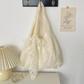 Detail of floral embroidery on a cream lace tote bag with a decorative bow accent - Beige with Large Bow