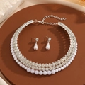 Elegant multi-layer pearl and rhinestone necklace with teardrop earrings on tray - Silver
