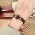 Elegant gold case ladies watch with vibrant red leather strap and red dial worn on wrist - Gold/Red (Round Crystal Markers)