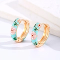 Detailed close-up of blue enamel floral hoop earrings with pink petals and gold finish - Green (Copper)