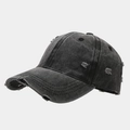 Detail of distressed grey cotton baseball cap with torn fabric on the curved brim - Black