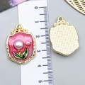 Detail of pink floral enamel charms with pearls and ruler for size reference - Rose Pink Gold-Sprinkled Pearl Bouquet-23584