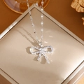 Silver bow necklace with sparkling cubic zirconia on a champagne jewelry box - A0108 Silver CZ Bowknot