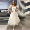 Elegante abito midi bianco in mesh a pois con maniche a sbuffo e silhouette slim - US size 2 (S) / Avorio