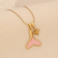 Detail view of gold necklace featuring pink mermaid tail and starfish charms on soft fabric - Pink Fish Tail Starfish Style