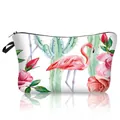 Detailed view of the flamingo and rose floral print on a polyester makeup bag - Black Cactus