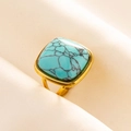 Detail of adjustable gold ring featuring a square blue turquoise stone on silk fabric - Gold Base-Light Blue Stone