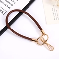 Detail of 6mm brown braided leather wrist strap with elegant gold metal clasp hardware - Coffee
