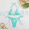 Detail of light blue floral bikini top featuring a golden flower pendant and halter ties - S / Cyan