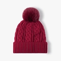 Chunky wine red cable-knit women's winter beanie featuring a soft faux fur pom-pom - One Size / Burgundy