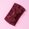 Detailed view of maroon waffle-knit baby headband with bow knot on pink background - Maroon Bow (4)