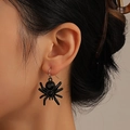 Close-up of a gothic spider earring with black gemstones worn on a model's ear - Double Black Gem Spider Style / White K (White K X640)